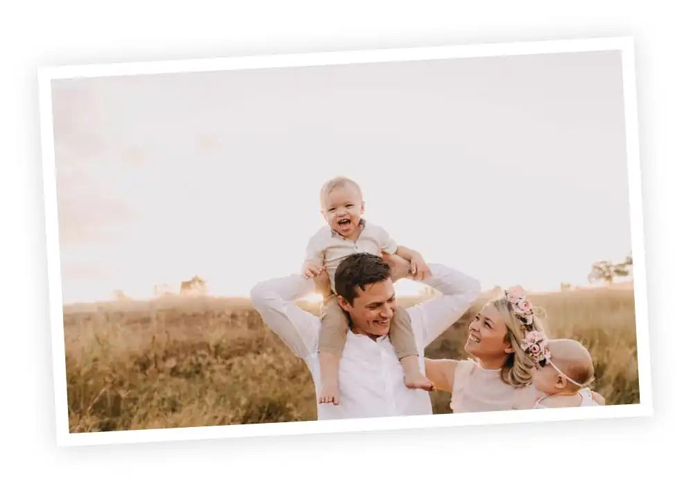 A joyful family moment captured in a sun-drenched field.